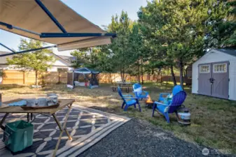 A well-packed gravel driveway welcomes you to this wooded-edge lot. Full hookups and privacy fencing make it a perfect long- or short-term RV spot.