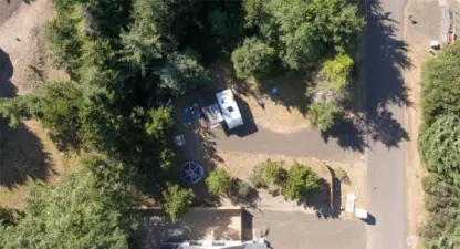 This inviting space is cleared and level, with trees on three sides and a fence to ensure seclusion. Includes full hookups and an easy-access gravel drive.