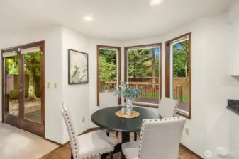 Breakfast nook with bay window overlooking the deck and rear yard