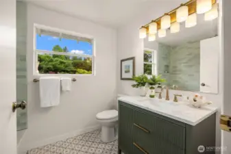 Brand new hall bath features stunning tile and a beautiful cabinet, new  lighting, faucet, countertops and toilet.