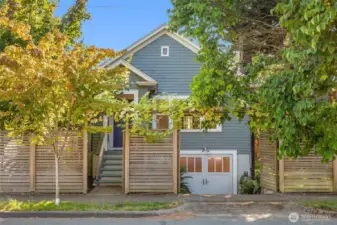 Well sited among mature landscaping with a custom cedar privacy fence.