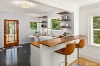 Open kitchen with a breakfast bar.