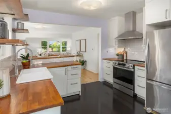 Efficient U-shaped cooking area with an induction range and vented hood.