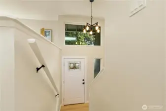 The entrance is grand with tall ceilings and a ton of natural light.