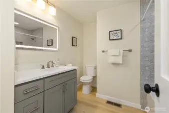 The guest bathroom upstairs has a touch of whimsy with colorful tile and matching cabinets.