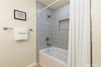 There is a tub/shower combo in this upstairs bathroom.