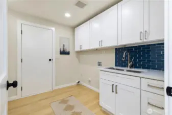 You will actually want to do laundry here! The laundry room is huge with SO much storage. This is also one way to access the back yard.