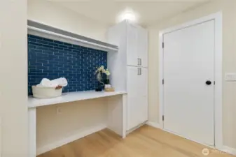 This is the other side of the laundry room with built-in folding table and room to hang your clothes.