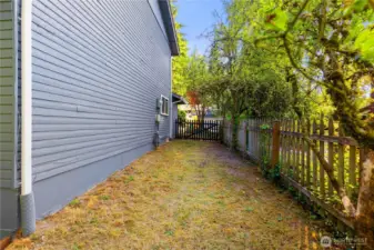 There is some green space on the side of the house.