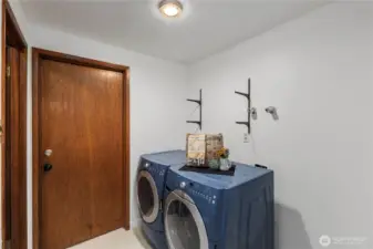 Laundry room, with half bath and connection to the garage