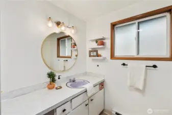 Full bathroom with a lot  of counter space and a linen closet.