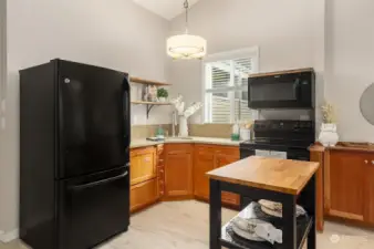 The updated kitchen with Thomasville cherry wood cabinets, quartz countertops and updated appliances is a chef’s delight.