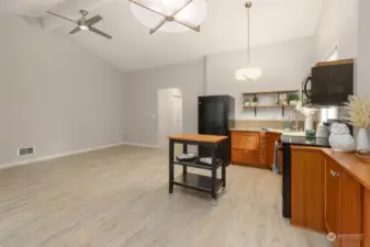 Two upper open display shelves and a butcher block island with two more additional stainless-steel shelves makes kitchen organization easier.  Butcher block table to remain.