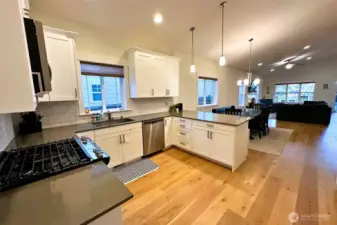 Quartz counters and crisp white cabinets and backsplash are timeless. Stove is propane.