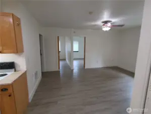 Looking across the dining room to the 2 upstairs bedrooms and bathroom on the far left -- from the kitchen.