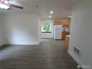 A view across the dining room toward the kitchen, pantry and stairs.