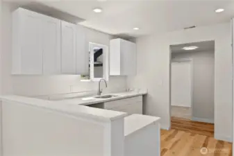 Kitchen looking back toward side entrance and bonus room