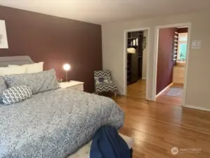 Primary suite facing dual closets.