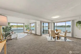 Open great room design combining living and dining spaces, oriented to capture sweeping Sound and bridge views.