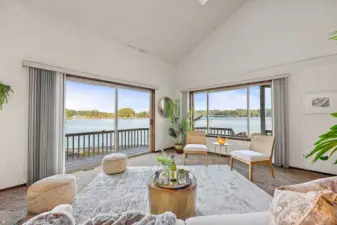 A water-facing living room offering stunning sightlines to the Harstine Island Bridge and surrounding Sound views.