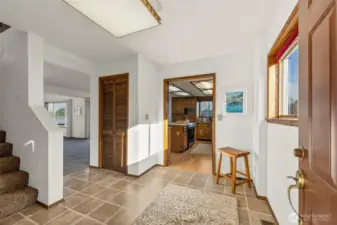 Inviting entry leads into a home that lives like a rambler, with primary bedroom on the main level.