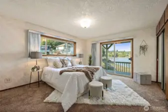 Primary bedroom opens to a deck, creating a quiet retreat with views.
