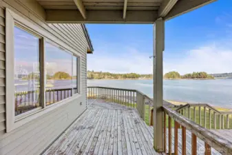 Outdoor decks connect seamlessly to the lawn and shoreline with no-bank access.