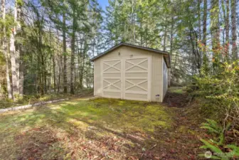 Spacious 556 sq ft detached garage with high ceilings and wide barn doors ideal for RV, boat, or multi-vehicle use.