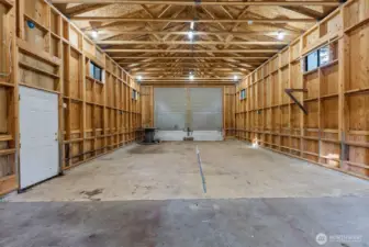 556 sq ft detached garage designed with high ceilings and oversized barn doors for flexible vehicle use.