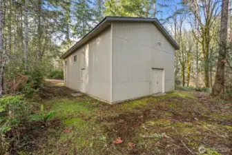 High-ceiling shop or garage offering flexible storage and workspace.