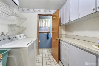 Walk in pantry in laundry area leads to half bath