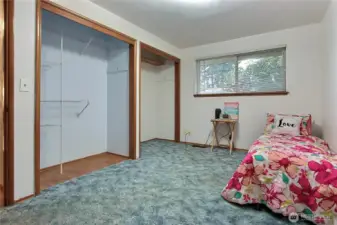 Guest bedroom #2 shows the exposed hardwood flooring