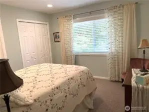 On the northeast side of the home is one of two guest bedrooms with two nice sized closets. Large window looks out to the beautiful front yard.