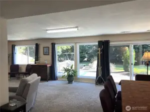 Large bank of floor to ceiling windows with views to the front yard and patio.