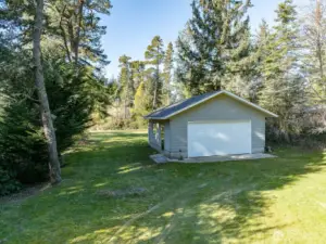 Second garage, workshop with side entrance and large window.