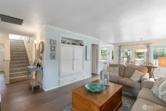 Living room and dining area. Stairs to Primary suite.