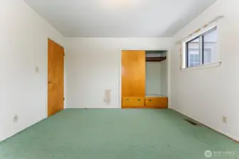 Bedroom 3 with built in storage, original wood floors under carpet