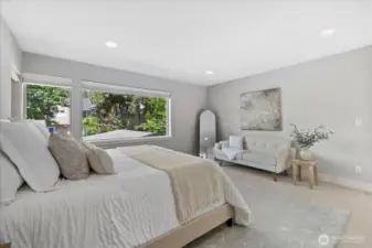 Expansive Primary bedroom easily fits a King size bed and seating area. Custom wood blinds included.
