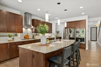 Chef-inspired kitchen with SS appliances, granite counters, an entertainment sized island and gas cooktop make cooking a dream!