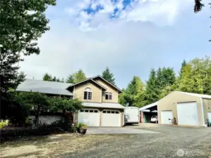 Left of the garage doors is the staircase to the covered porch/deck