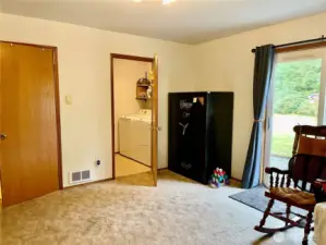 Base of the stairs to Closed door is 1/2   bath, facing me is utility room and beside, left me garage access. Gun safe stays!