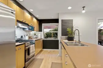 High-end stainless steel appliances, a newer gas range, and tons of storage space make this kitchen a dream to cook in.