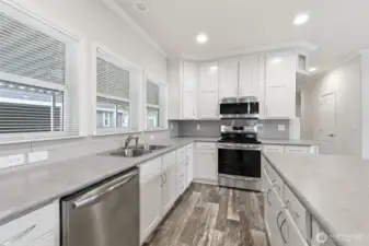 Thoughtfully planned kitchen with ample counter space, storage, and bright windows for a fresh, welcoming feel.