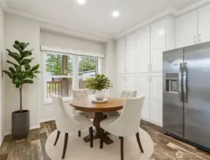 Light-filled dining room with large windows and easy access to the oversized pantry—perfect for everyday meals or hosting friends. (Photo virtually staged)