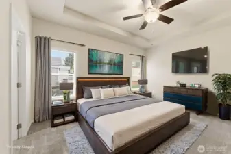 Elegant primary suite with tray ceiling, walk-in closet, and spa-inspired bath for comfort and relaxation.