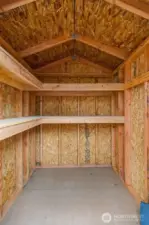 Interior of shed includes sturdy shelving—perfect for tools, gardening supplies, or seasonal décor.