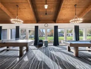Spacious game room with billiards and seating areas—an inviting space to meet neighbors and enjoy friendly competition.