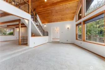 Living room has a open ceiling to the loft two steps up to the family room which is off of the kitchen