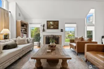 Formal living room right off the entry with vaulted ceilings and fireplace; A perfect conversation room.