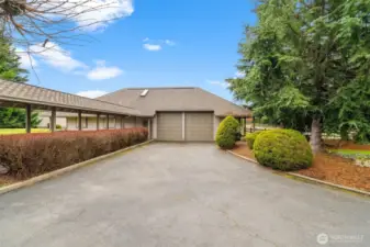 View of the heated shop with the covered walkway/breezeway from the main house and 3-car garage.